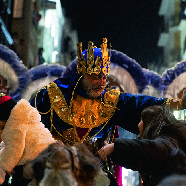 Three Kings Day celebration in Spain with illuminated floats and crowds