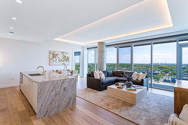 Open-plan kitchen and living room with large windows at JW Marriott Residences Reston Station